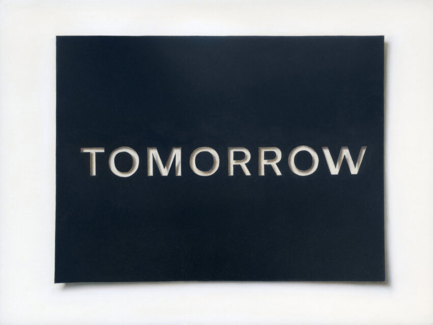 Letters spelling "Tomorrow" cut out from black paper on white background